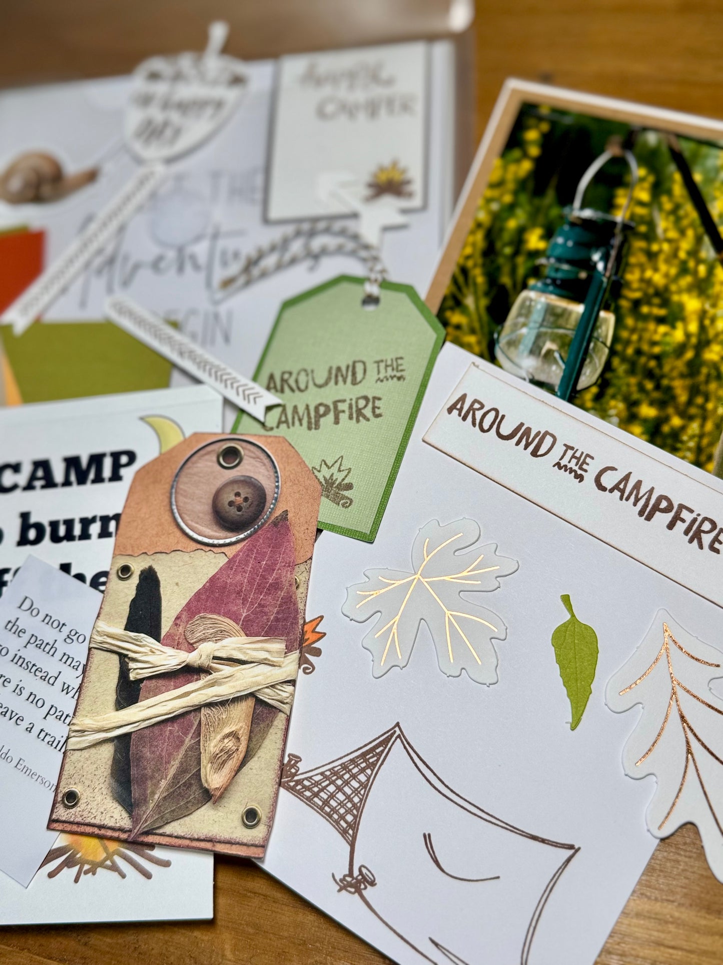 Collection of cards with camping-themed designs on a wooden surface