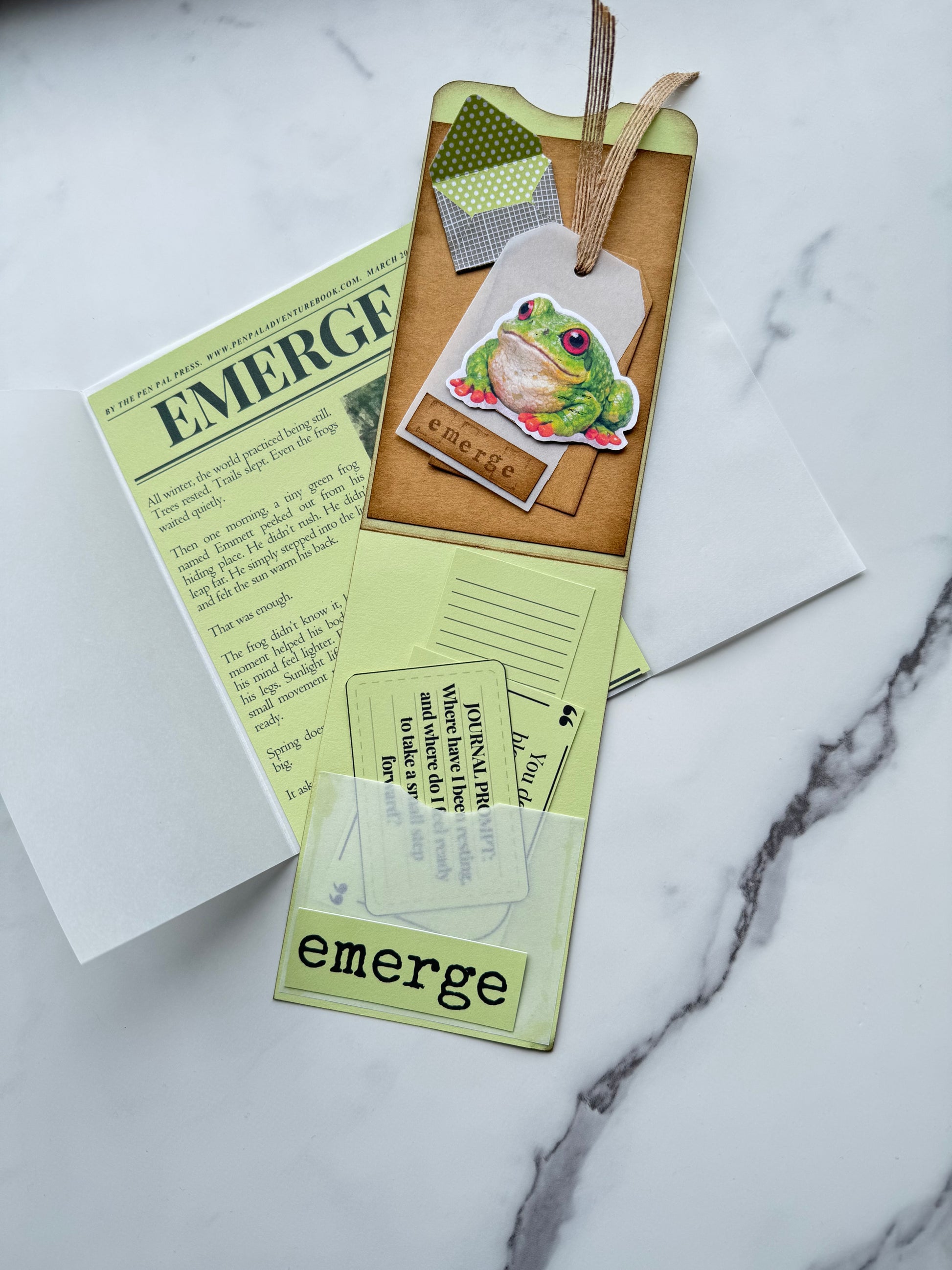 Open journal with stickers and a pen on a marble surface