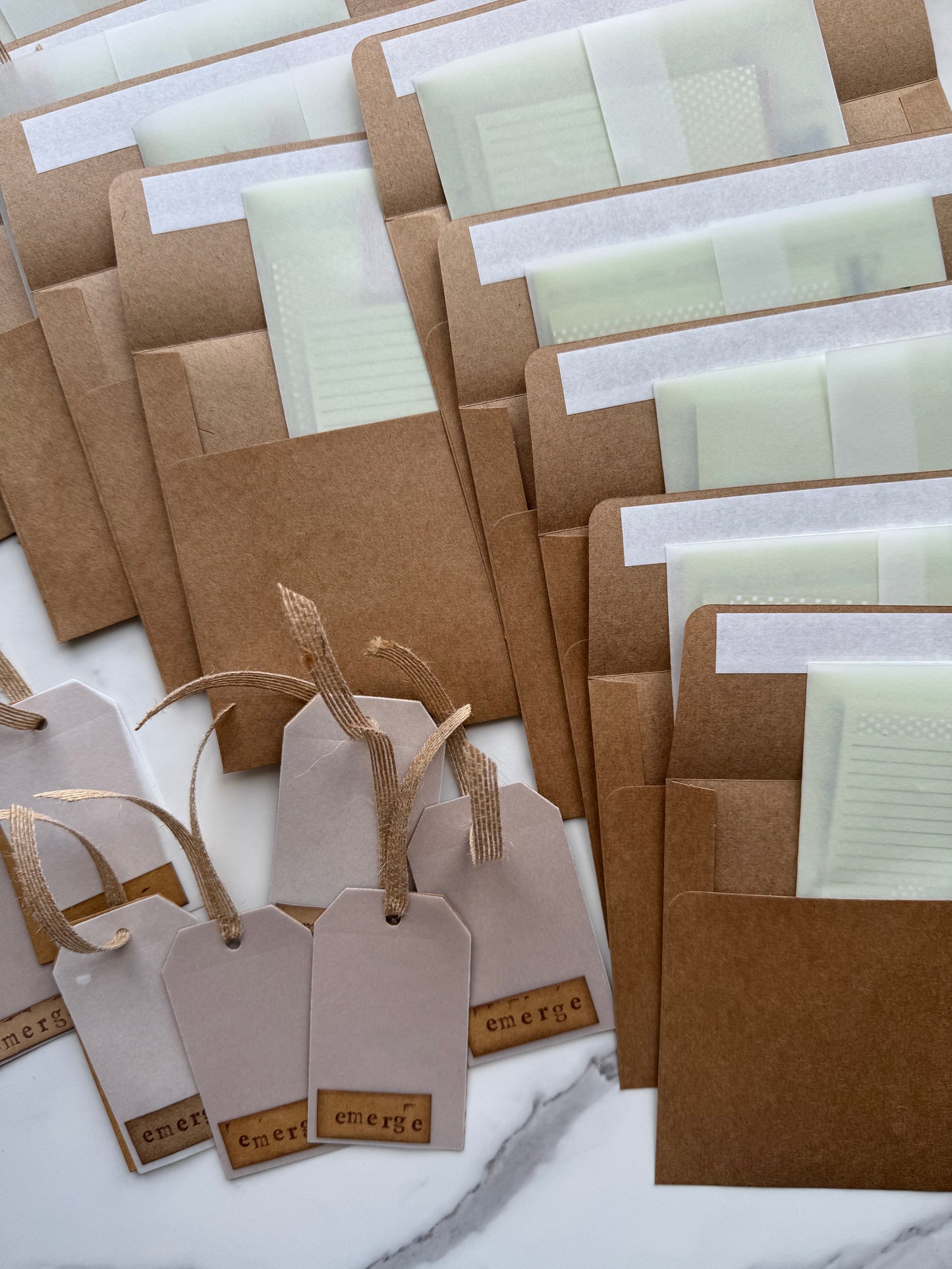 Collection of brown paper bags and tags on a white surface